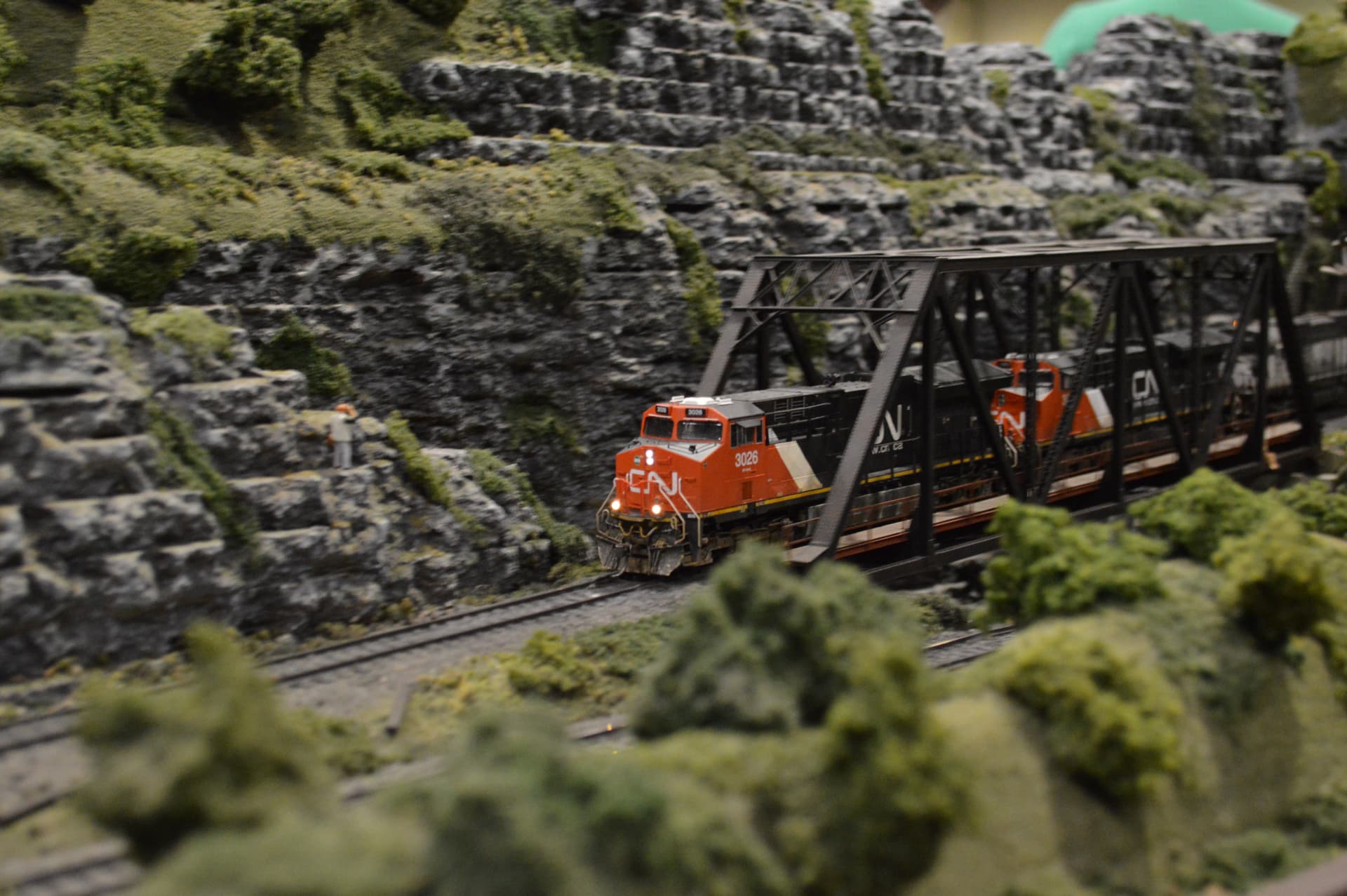 CN locomotives crossing a bridge through rock cuts